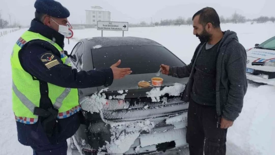 Yolda kalan araçlara zincir takan güvenlik güçlerinden sürücülere çorba ikramı